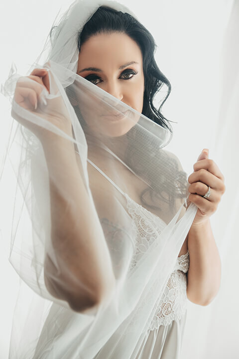 Bridal boudoir in Melbourne, bride in white lace holding her veil