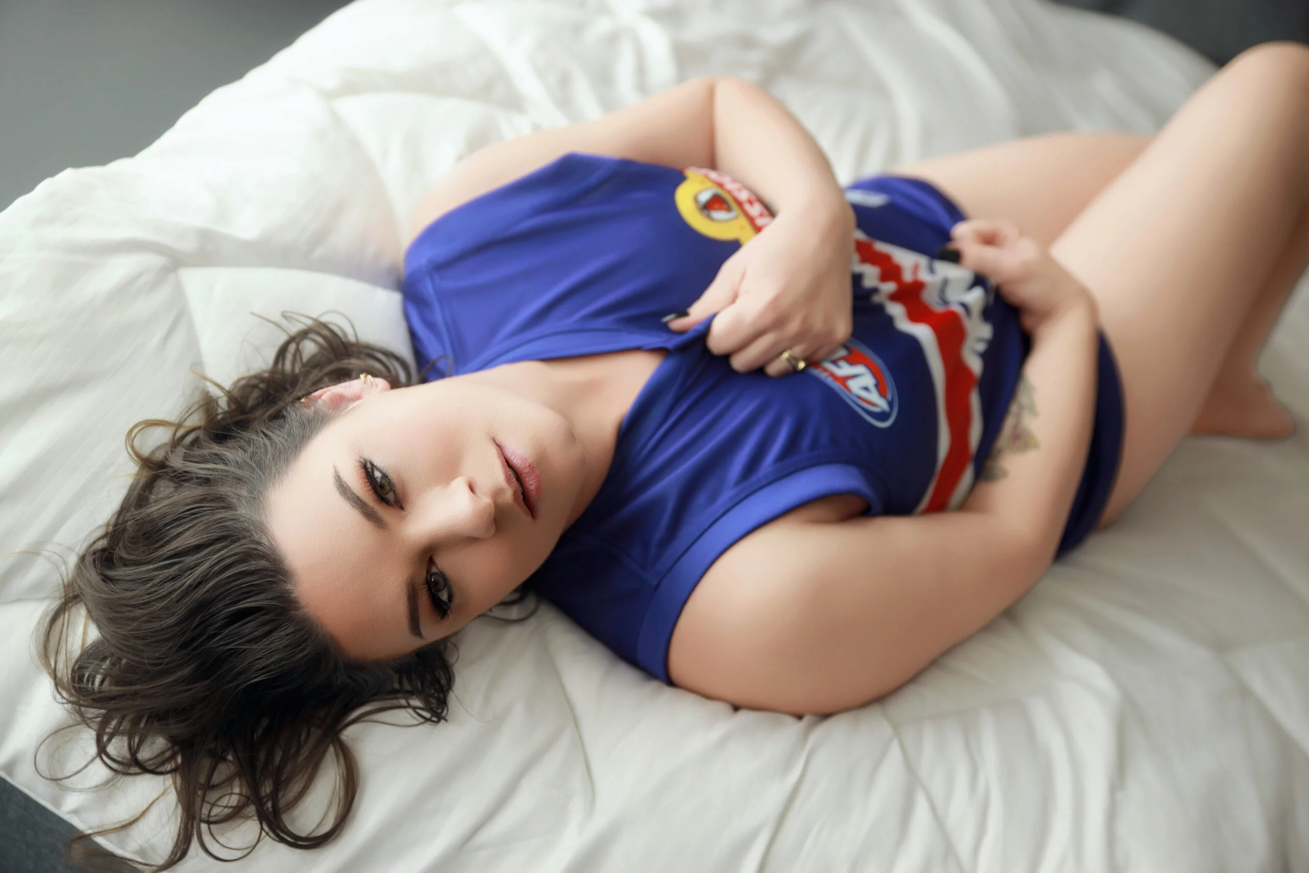 Playful boudoir portrait in a sports jersey