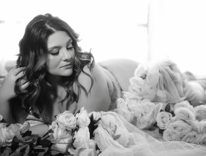 Curvy woman surrounded by pink roses, Bridal Boudoir in Melbourne at My Story Boudoir Melbourne