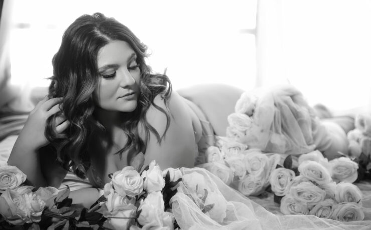 Curvy woman surrounded by pink roses, Bridal Boudoir in Melbourne at My Story Boudoir Melbourne